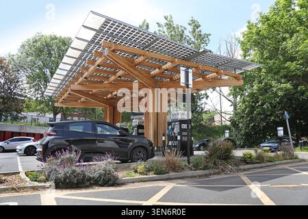 Stazione di ricarica per auto elettriche ESB Energy a Woolwich, a sud-est di Londra. Auto parcheggiate sotto una nuova struttura a baldacchino in legno laminato. Foto Stock