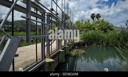È in atto una struttura in acciaio per gestire il flusso d'acqua in un canale di irrigazione che fornisce acqua alle risaie a Valencia, in Spagna. Il set Foto Stock