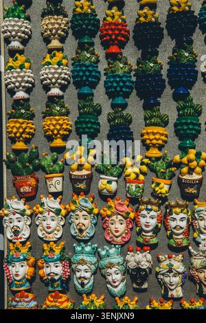 Magneti in ceramica tradizionale colorata, come il pinecone e il cactus, disposti in file su un'esposizione. Foto di alta qualità Foto Stock