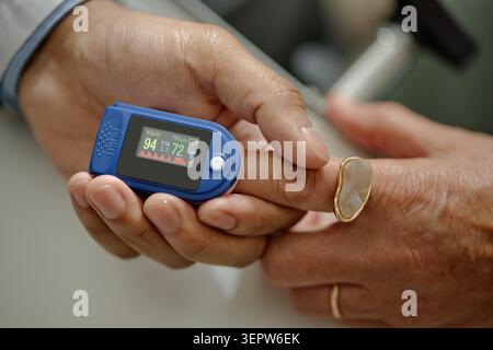 Paziente senior sottoposto a controllo pulsossimetro durante la visita clinica Foto Stock