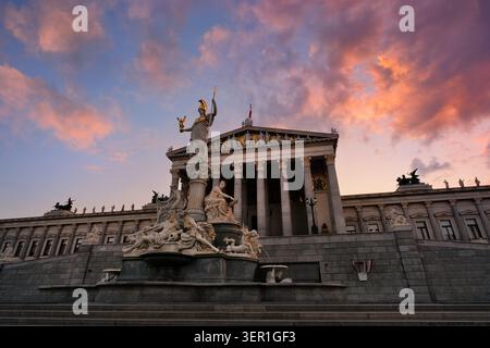 Edificio del Parlamento austriaco al tramonto. Famosa architettura storica di Vienna, Austria, con un magnifico cielo luminoso e nuvole colorate illuminate Foto Stock