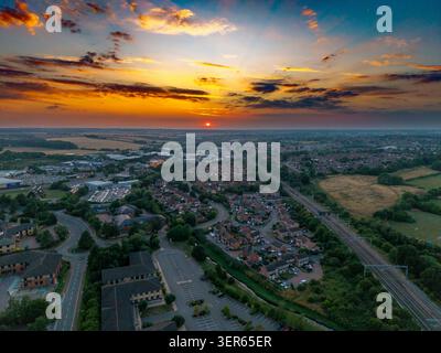 Questa immagine cattura un vibrante tramonto sulla città di Kettering, Northamptonshire Foto Stock