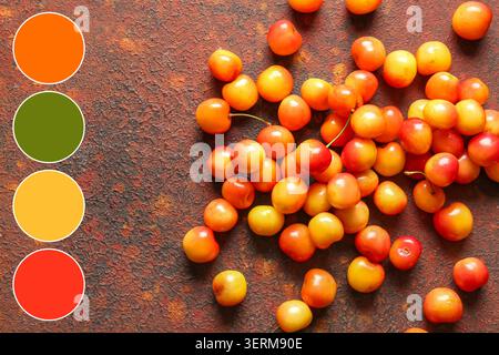 Ciliegie rainier fresche con tavolozza di colori su sfondo rustico, mangiare sano e frutta estiva Foto Stock