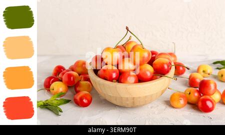 Ciliegie rainier fresche in ciotola di legno su fondo bianco testurizzato, sano spuntino di frutta estiva Foto Stock