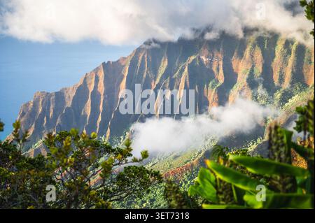 Le suggestive scogliere della costa di Na Pali avvolte da nuvole e luce d'oro, Kauai, Hawaii, Stati Uniti Foto Stock
