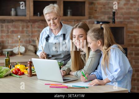 Figlia di madre e nonna avendo divertimento durante la cottura Foto Stock