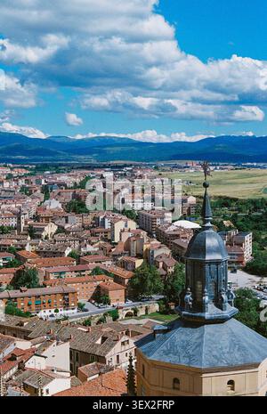 Vista panoramica sopraelevata sulla storica città di Segovia, in Spagna, con un campanile in primo piano, tradizionali tetti in terracotta Foto Stock