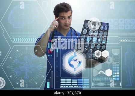 Giovane medico guardando immagine a raggi x nel concetto di mhealth Foto Stock