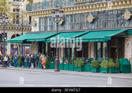 Facciata del ristorante Cafe de la Paix con tende verdi e terrazza esterna. Parigi, Francia - 13 ottobre 2025 Foto Stock