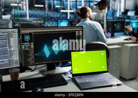 Gli ingegneri lavorano con un notebook in un hub server per supportare i sistemi di intelligenza artificiale. Foto Stock