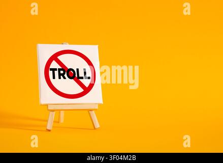 Cavalletto su tela che mostra un cartello "Niente troll", simboleggiante la sicurezza su internet, l'etica digitale e la moderazione dei social media Foto Stock