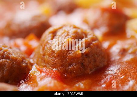 Deliziose polpette che cuociono a fuoco lento in una salsa di pomodoro saporita Foto Stock