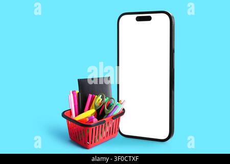 Smartphone con schermo vuoto e cestino di cancelleria colorata Foto Stock
