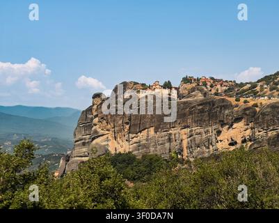 Kalambaka, Grecia - 24 luglio 2024: gruppo di monasteri Meteora: a sinistra c'è Varlaam con il suo piccolo padiglione aperto per le campane, e a destra c'è il Grande Meteoron, grande Foto Stock