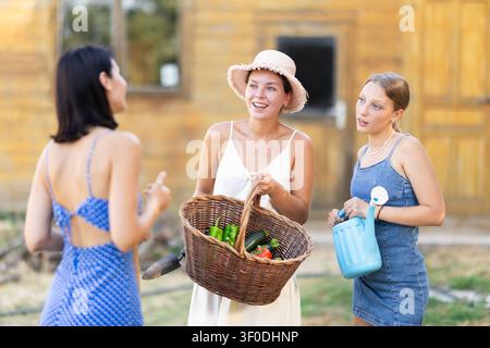 Tre donne che parlano alla casa di campagna Foto Stock
