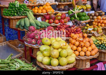 Stallo di frutta colorato al famoso mercato degli agricoltori di Funchal, Madeira, che espone una grande varietà di frutti tropicali ed esotici, tra cui la frutta del drago. Foto Stock