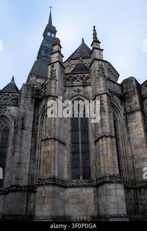 Vista esterna della Basilica di Saint-Sauveur con facciata in pietra, finestre gotiche, contrafforti, pinnacoli del tetto e campanile a Dinan, Cotes-d Armor, F Foto Stock