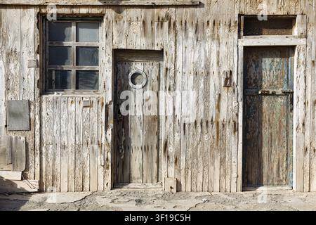 Capanne rustica con facciata in legno stagionato, architettura costiera tradizionale in legno, dettaglio, porte e finestre, appartamento dei lavoratori, insediamento storico Foto Stock