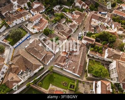Vista aerea della storica città di Óbidos con i suoi tetti tradizionali in terracotta, le strade strette e i giardini lussureggianti a Óbidos, distretto di Leiria, Portogallo Foto Stock