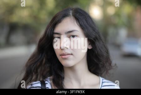Giovane donna con uno sguardo serio all'aperto Foto Stock