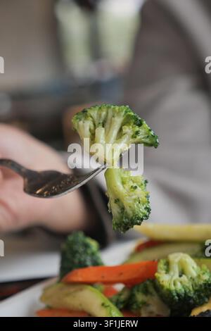 Broccolo fresco su una forchetta in un ambiente da ristorante Foto Stock