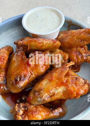 Piatto di ali di pollo, con salsa all'aioli a lato Foto Stock
