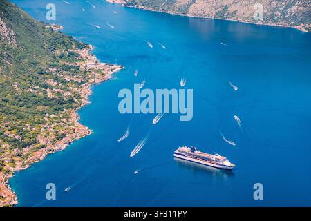 Baia di Kotor, Montenegro, vista aerea che mostra una nave da crociera e molte piccole barche che si muovono sull'acqua blu Foto Stock