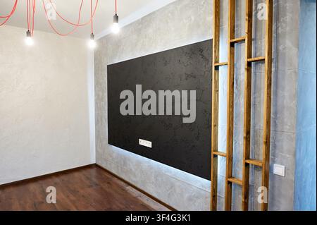 Camera di appartamento contemporaneo con parete d'accento illuminata e pavimento laminato in legno. Spazio abitativo pulito, arredamento moderno e concetto di ristrutturazione. Foto Stock
