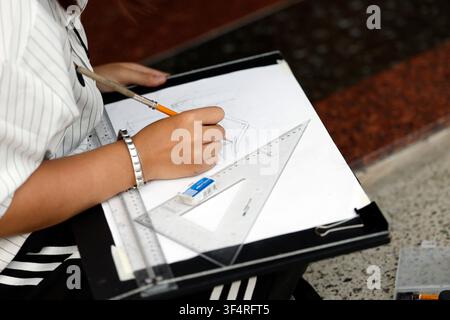 Pagoda Vietnam Quoc Tu. Una persona sta disegnando uno schizzo architettonico su una tavola da disegno, utilizzando una matita, un righello e un quadrato per garantire la precisione. Foto Stock