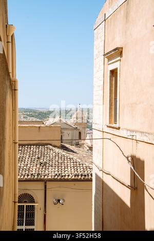 Vista dal tetto su una strada italiana illuminata dal sole nel centro storico di Noto, Sicilia, Italia meridionale Foto Stock