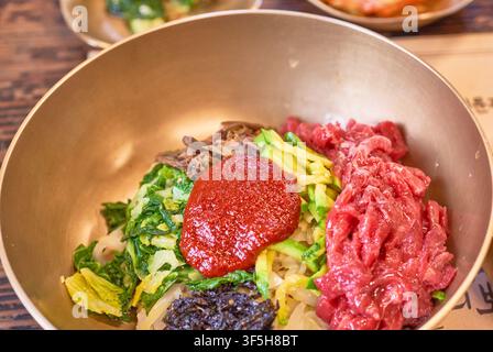 Yukhoe bibimbap, bibimbap coreano con manzo crudo, verdure e pasta al peperoncino, servito in un ristorante tradizionale a Jinju. Foto Stock
