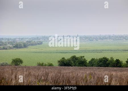 Area del bacino di Kakhovka nella regione di Kherson, bacino idrico prosciugato con nuova crescita forestale sulle rive del fiume, visto dal lato destro che si affaccia sull'ex paesaggio Foto Stock