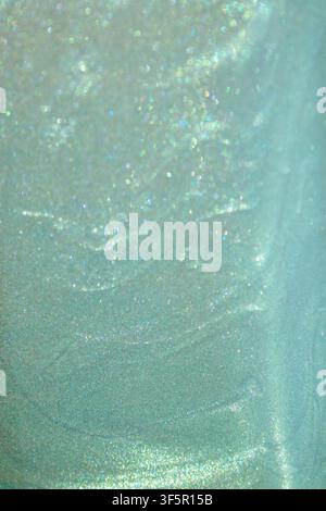Texture scintillante verde menta con morbido bokeh e sfondo iridescente luccicante Foto Stock
