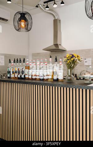 Belgrado, Serbia - 29 luglio 2026. Bottiglie di sciroppi aromatizzati Monin e 1883 disposte su un bancone del caffè, che mostrano una selezione di ingredienti per bevande Foto Stock