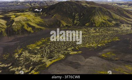 Prospettiva a drone di un cono vulcanico ricoperto di muschio e di una pianura di lava scura a Skaftárhreppur, Islanda. Foto Stock