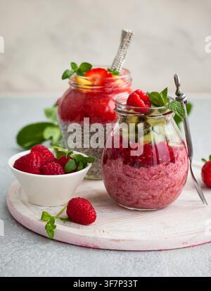 Budini di semi di chia con frutti di bosco e frutta per colazione Foto Stock