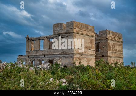 Resti di storia sull'isola di Suakin con cielo nuvoloso e vegetazione in Sudan Foto Stock