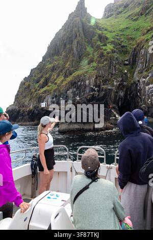 Turisti che osservano le scogliere di Skellig Michael da una barca, Contea di Kerry, Irlanda. Foto Stock