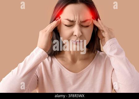 Donna che soffre di un forte mal di testa o emicrania, si preme le tempie con le mani, dolore e stress Foto Stock