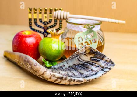 Simboli delle festività di Rosh Hashanah, tra cui lo shofar, il miele, le mele e il melograno, pronti per la celebrazione Foto Stock