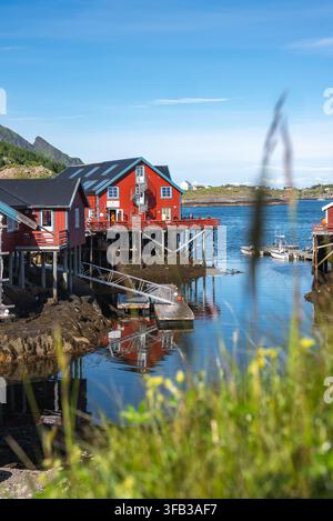 Le tradizionali cabine rorbu si ergono su palafitte a Henningsvaer Foto Stock