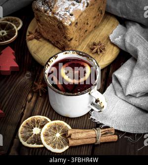 Vin brulé in un ferro bianco mug e torta al forno con frutta secca, vista dall'alto Foto Stock