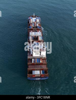 Vista aerea di una grande nave portacontainer carica di container colorati che naviga nelle acque blu profonde vicino alla costa di Lagos, Lagos, Nigeria. Foto Stock