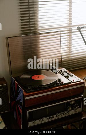 Lettore di dischi vintage che gira il vinile in un ambiente retrò Foto Stock