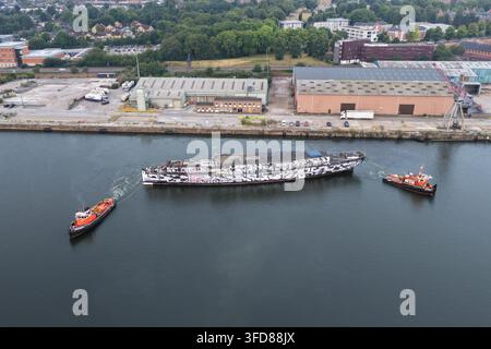L'antica nave da guerra HMS President viene trascinata lungo il Tamigi nel suo ultimo viaggio verso il deposito di rottami di Erith, Londra, Regno Unito, il 17 luglio 2026. Foto Stock