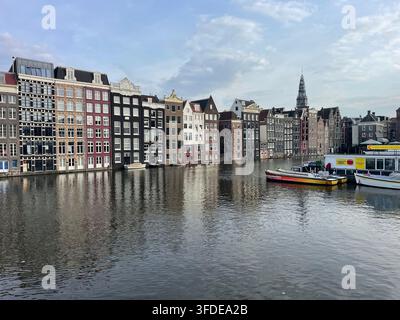 Le case del quartiere Damrak di Amsterdam si riflettono nell'acqua del canale Foto Stock