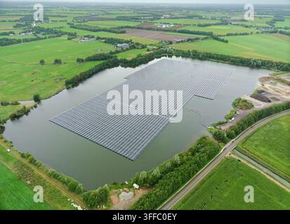 Pannelli solari galleggianti sul lago che generano energia verde sostenibile, elettricità per una piccola città nei Paesi Bassi, vista aerea Foto Stock