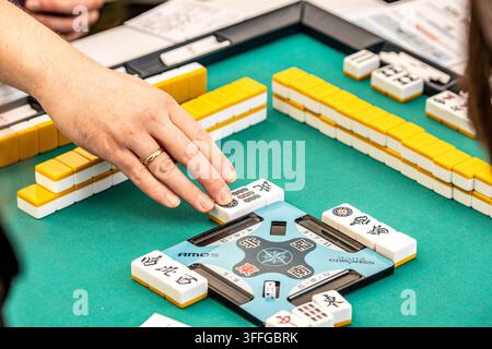 Persone che giocano a Mahjong per strada, un gioco a piastrelle per tre o quattro giocatori Foto Stock