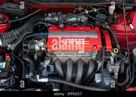 Kemptthal, Zurigo, Svizzera, 6 settembre 2026. Vista dall'alto del vano motore di una Honda DOHC VTEC rossa con copriventola rosso, collettore di aspirazione e collettori. Foto Stock