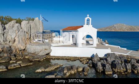 Piccola chiesa di Agios Isidoro nel mare sopra le rocce, isola di Chios, Grecia. Foto Stock
